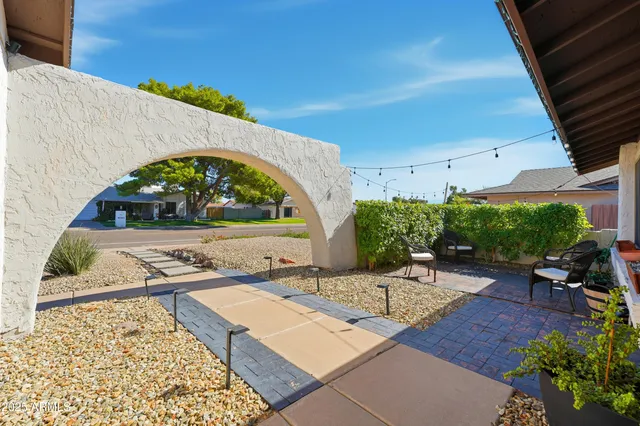 a view of a backyard with sitting area