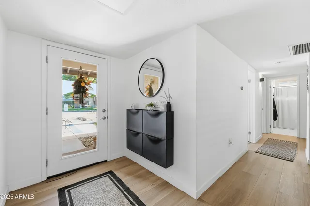 a view of a room with wooden floor and white walls