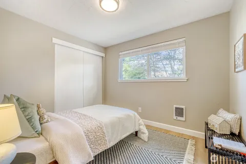 a bedroom with a bed and a table