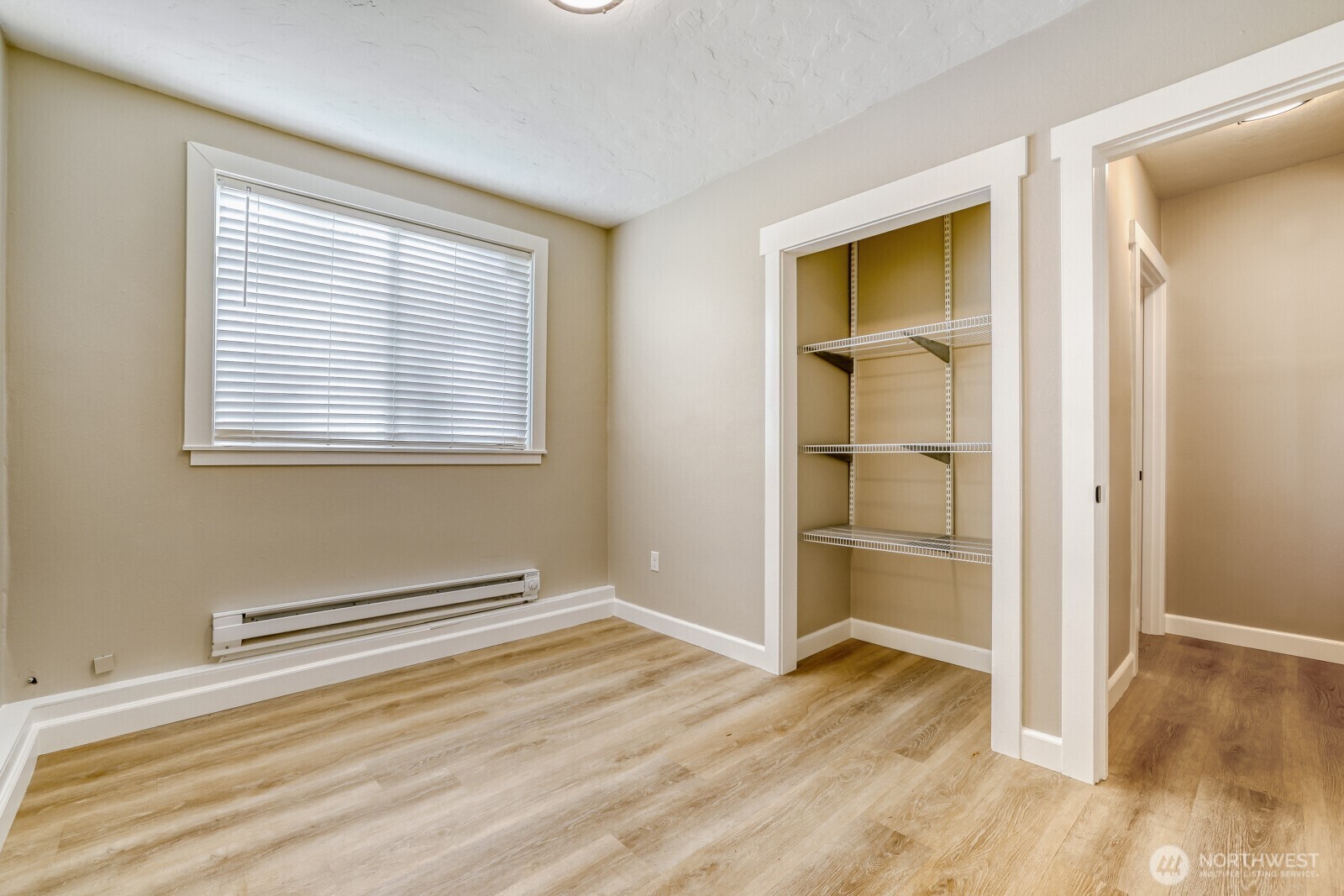 112 Raspberry Lane Sultan, WA 98294 - Photo 18 of 25 a view of an empty room with wooden floor and a window