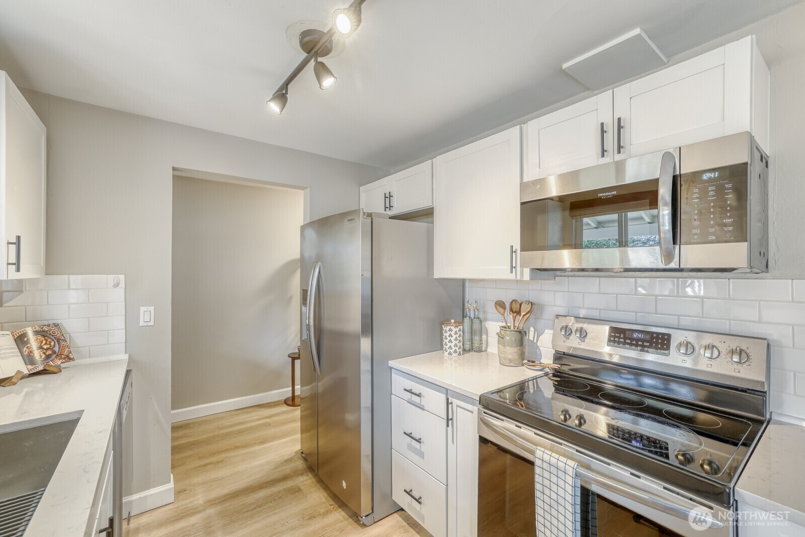 112 Raspberry Lane Sultan, WA 98294 - Photo 6 of 25 a kitchen with stainless steel appliances granite countertop a stove and a refrigerator