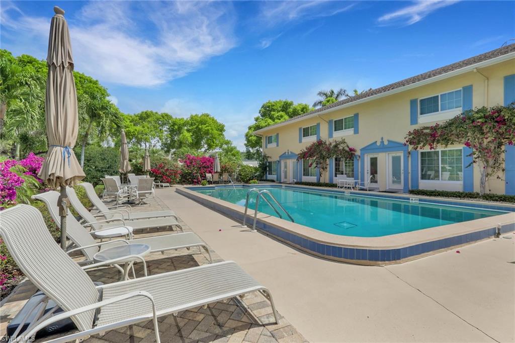 230 3rd Avenue South, Unit 4 Naples, FL 34102 - Photo 1 of 22 a view of a patio with table and chairs and potted plants
