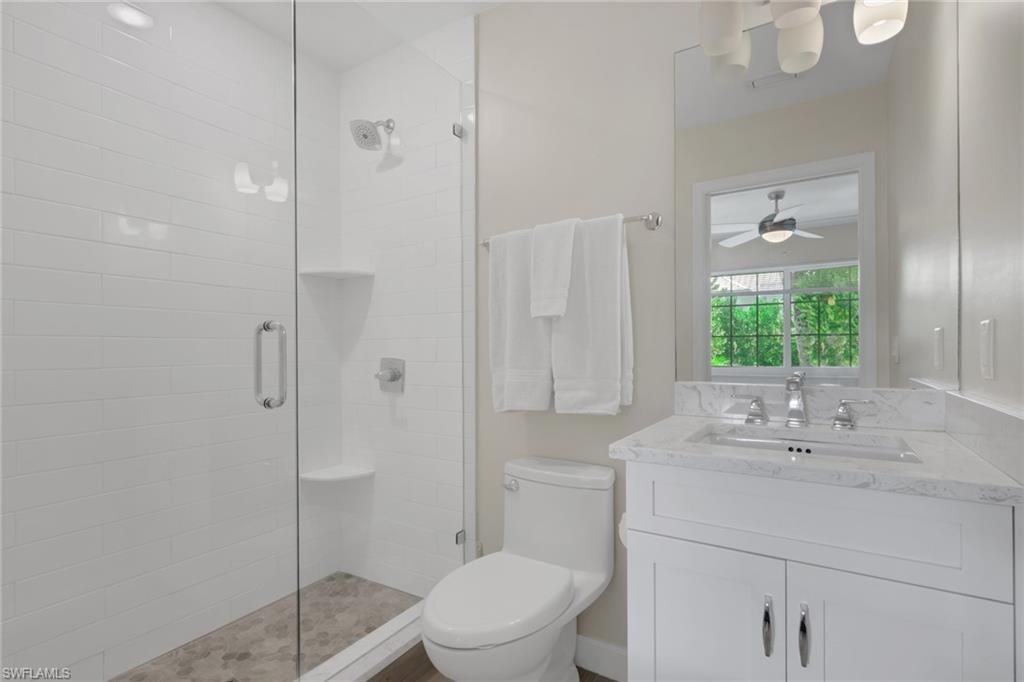 230 3rd Avenue South, Unit 4 Naples, FL 34102 - Photo 13 of 22 a bathroom with a sink a toilet and shower