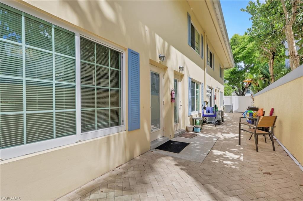 230 3rd Avenue South, Unit 4 Naples, FL 34102 - Photo 15 of 22 a view of a house with backyard and sitting area