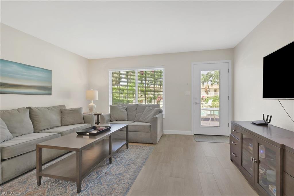 230 3rd Avenue South, Unit 4 Naples, FL 34102 - Photo 2 of 22 a living room with furniture and a flat screen tv