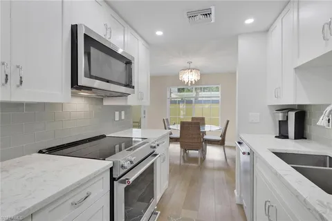 a kitchen with a stove a sink and a microwave