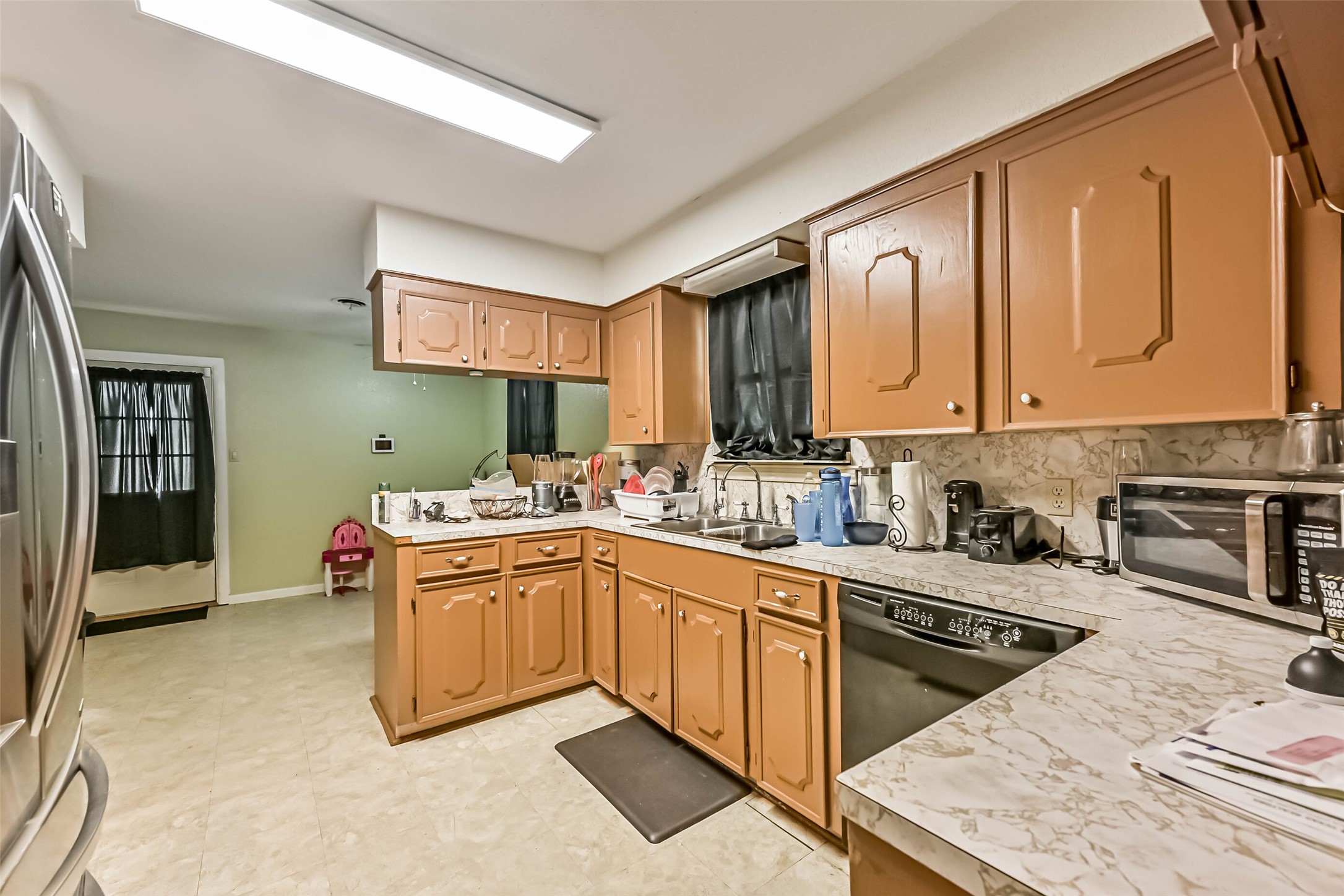 103 Deaton Street Freeport, TX 77541 - Photo 12 of 25 a kitchen with stainless steel appliances granite countertop a sink stove and cabinets