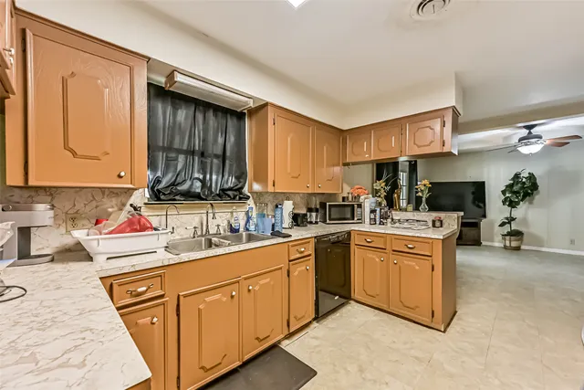 a kitchen with cabinets a sink and appliances