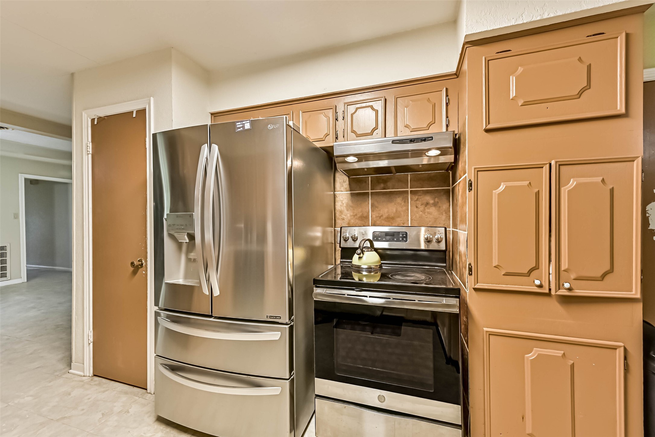103 Deaton Street Freeport, TX 77541 - Photo 14 of 25 a metallic refrigerator freezer sitting in a kitchen