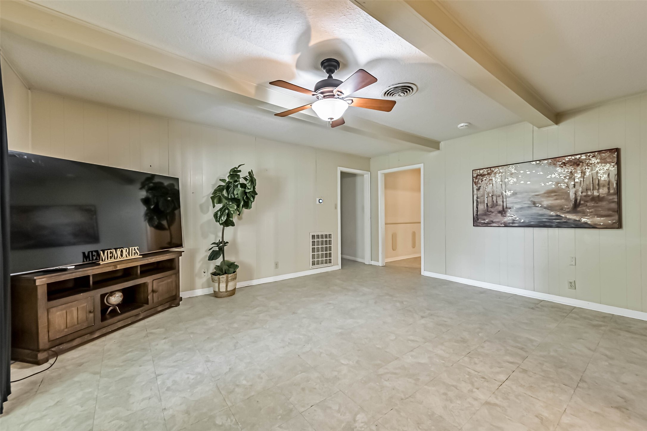 103 Deaton Street Freeport, TX 77541 - Photo 17 of 25 a view of a livingroom with a flat screen tv ceiling fan and window