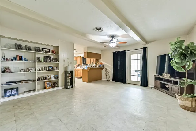 a view of an empty room with shelves and a workspace
