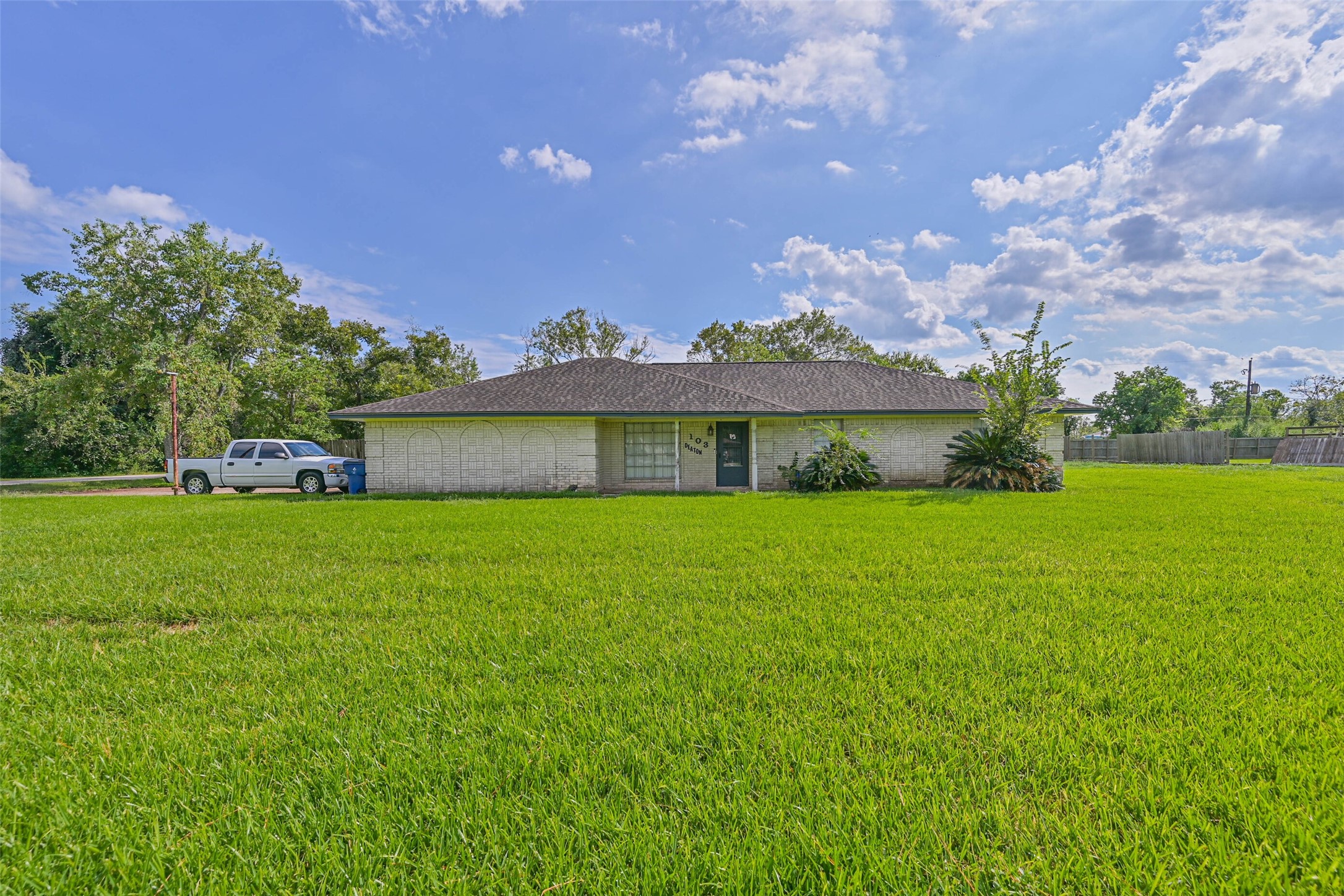 103 Deaton Street Freeport, TX 77541 - Photo 2 of 25 a front view of a house with a yard and garage