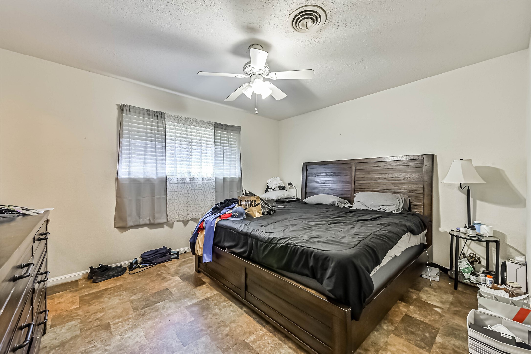 103 Deaton Street Freeport, TX 77541 - Photo 21 of 25 a bedroom with a bed and wooden floor
