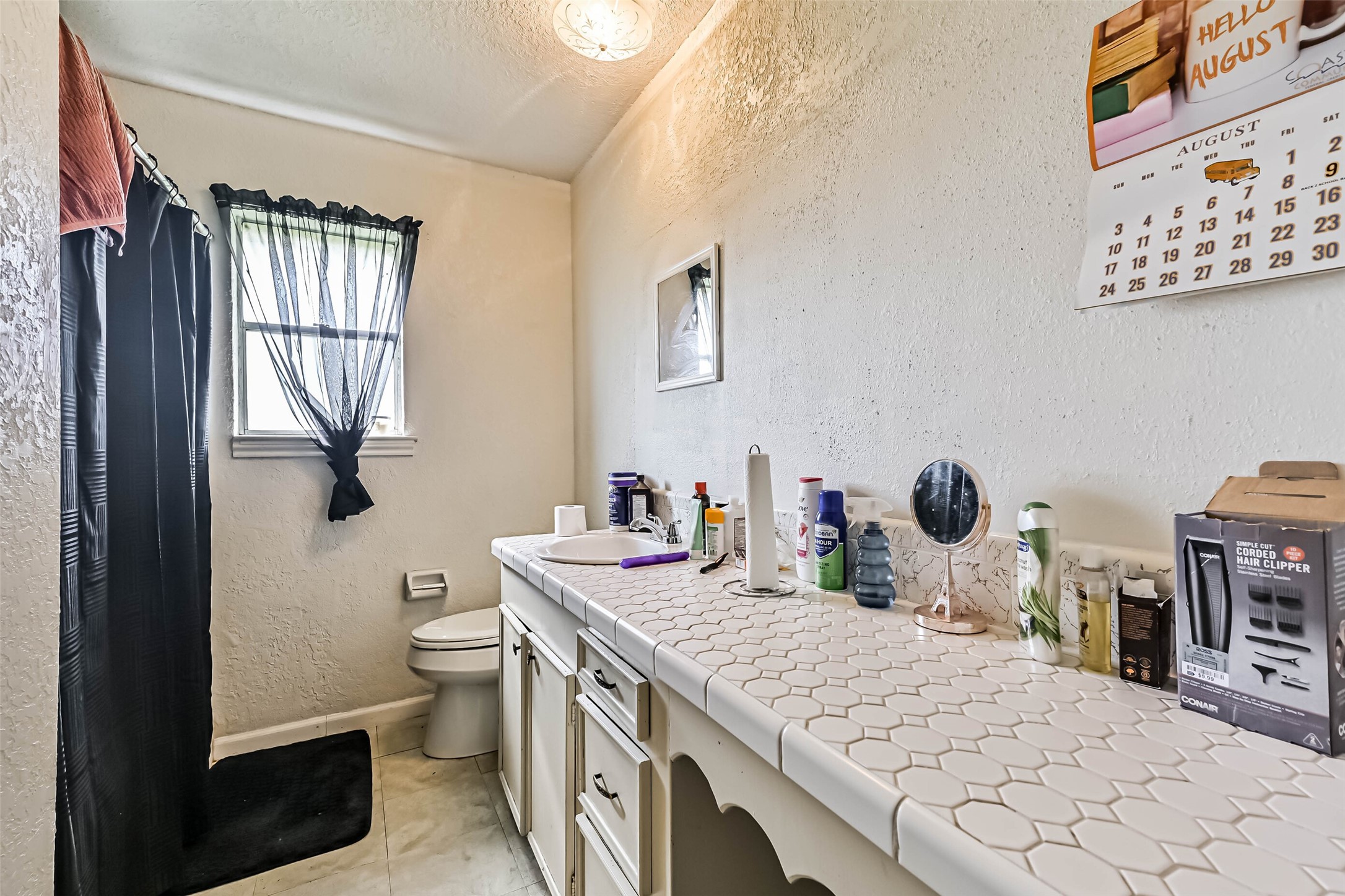 103 Deaton Street Freeport, TX 77541 - Photo 22 of 25 a bathroom with a sink a toilet and mirror