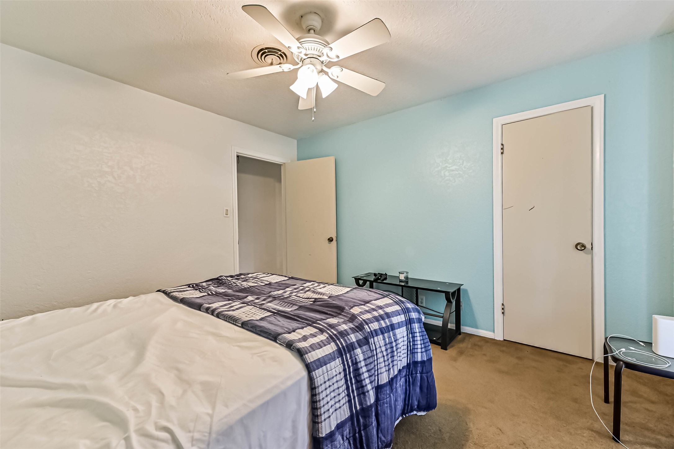 103 Deaton Street Freeport, TX 77541 - Photo 23 of 25 a bedroom with a large bed and a chandelier