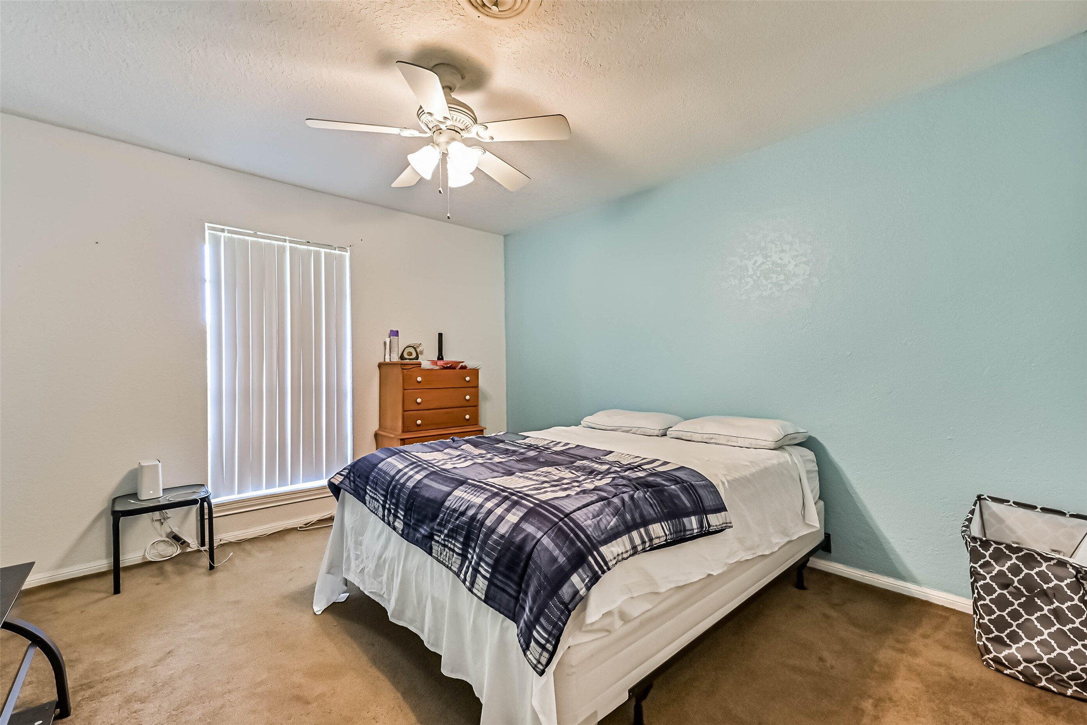 103 Deaton Street Freeport, TX 77541 - Photo 24 of 25 a bedroom with a bed and a chandelier
