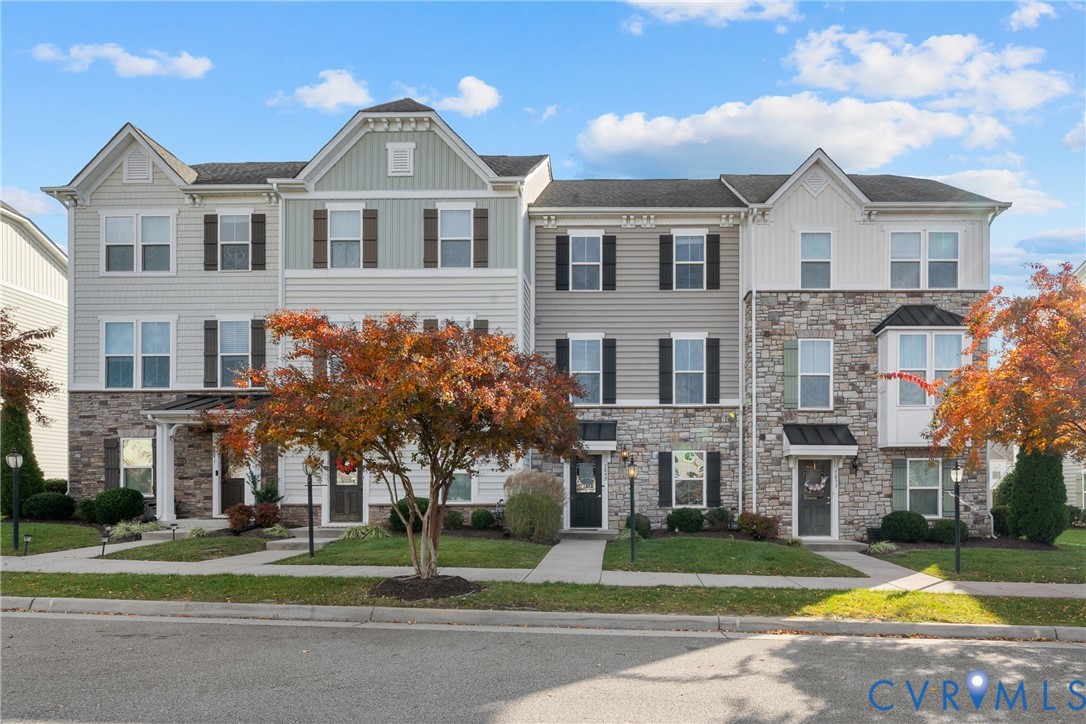 View of front of home featuring stone siding and b