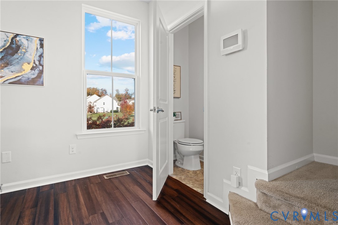 7849 Chasing Lane Richmond, VA 23237 - Photo 18 of 29 Bathroom with dark wood-style floors and baseboard