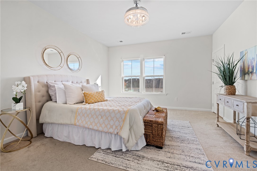 7849 Chasing Lane Richmond, VA 23237 - Photo 19 of 29 Bedroom with carpet floors and a chandelier