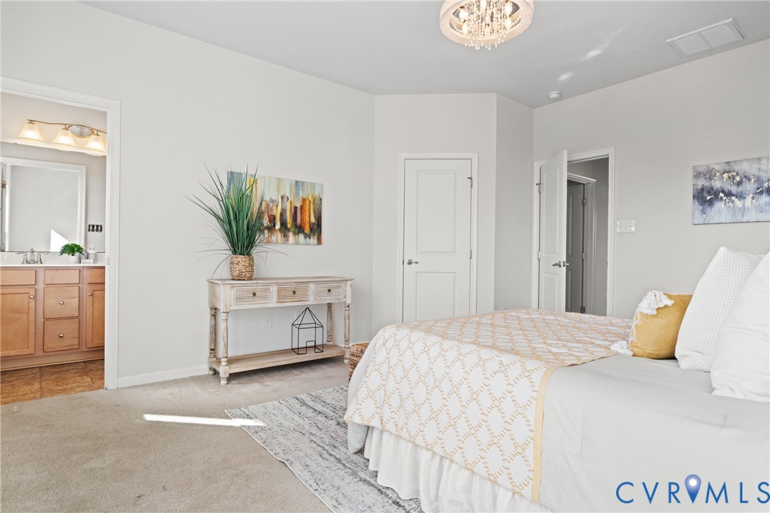 7849 Chasing Lane Richmond, VA 23237 - Photo 20 of 29 Carpeted bedroom featuring ensuite bathroom and a