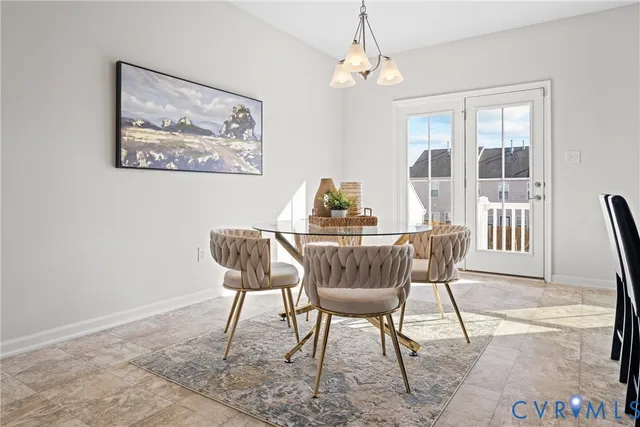 a dining room with furniture a chandelier and wooden floor