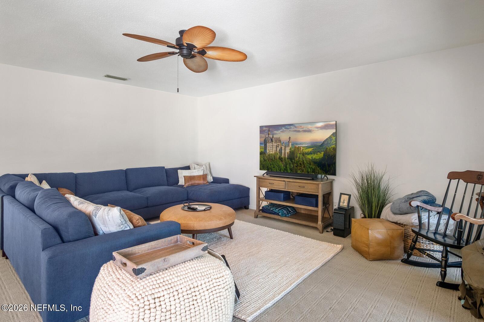8012 Hollyridge Road, Unit 17U Jacksonville, FL 32256 - Photo 7 of 22 a living room with furniture a window and a flat screen tv