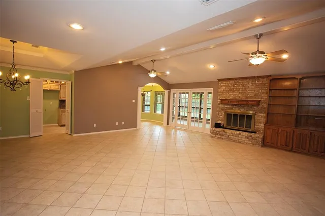 a view of a livingroom with a fireplace cabinet and window