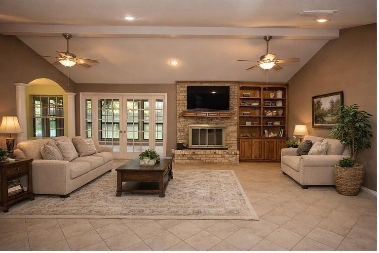 1305 Cliff Drive Graham, TX 76450 - Photo 13 of 37 a living room with furniture a fireplace and a flat screen tv
