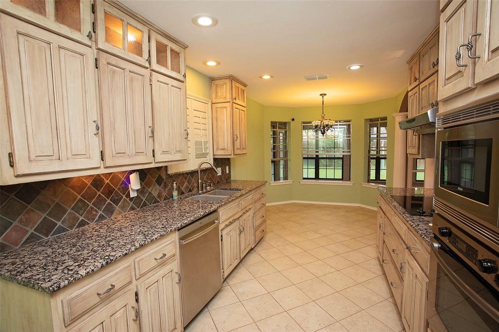 1305 Cliff Drive Graham, TX 76450 - Photo 19 of 37 a large kitchen with kitchen island granite countertop a large window