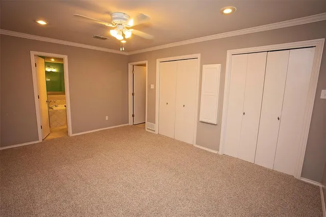 a view of a room with a ceiling fan