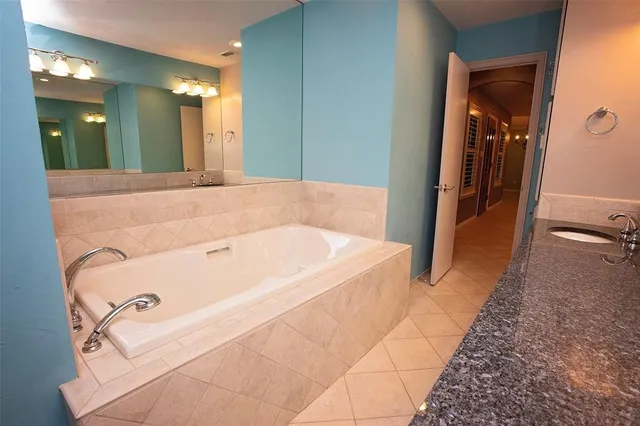 a bathroom with a tub and shower