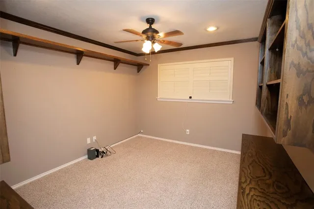 a view of a livingroom with a ceiling fan and a window
