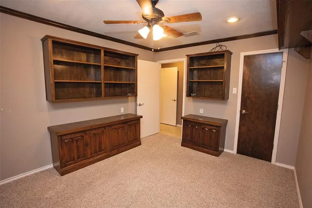 a view of an empty room with a cabinet and a cabinet