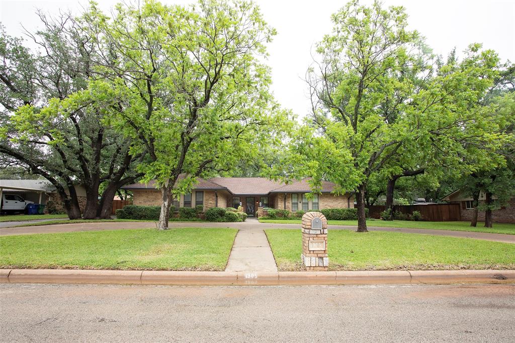 1305 Cliff Drive Graham, TX 76450 - Photo 4 of 32 a front view of a house with a yard and large trees