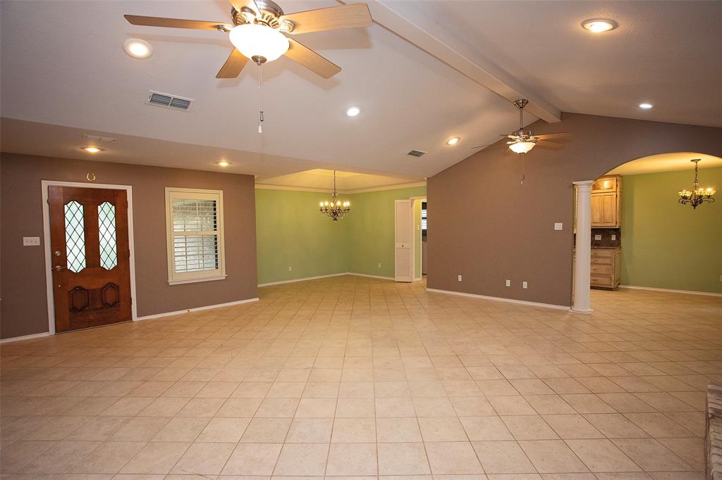 1305 Cliff Drive Graham, TX 76450 - Photo 10 of 32 a view of an empty room with window and a ceiling fan