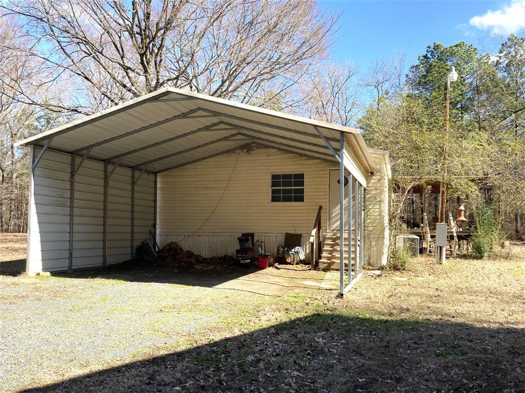 9515 Caddo Lake Road Mooringsport, LA 71060 - Photo 12 of 12 a view of a house with snow on the road