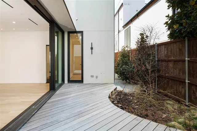 a view of a room with wooden floor and fence