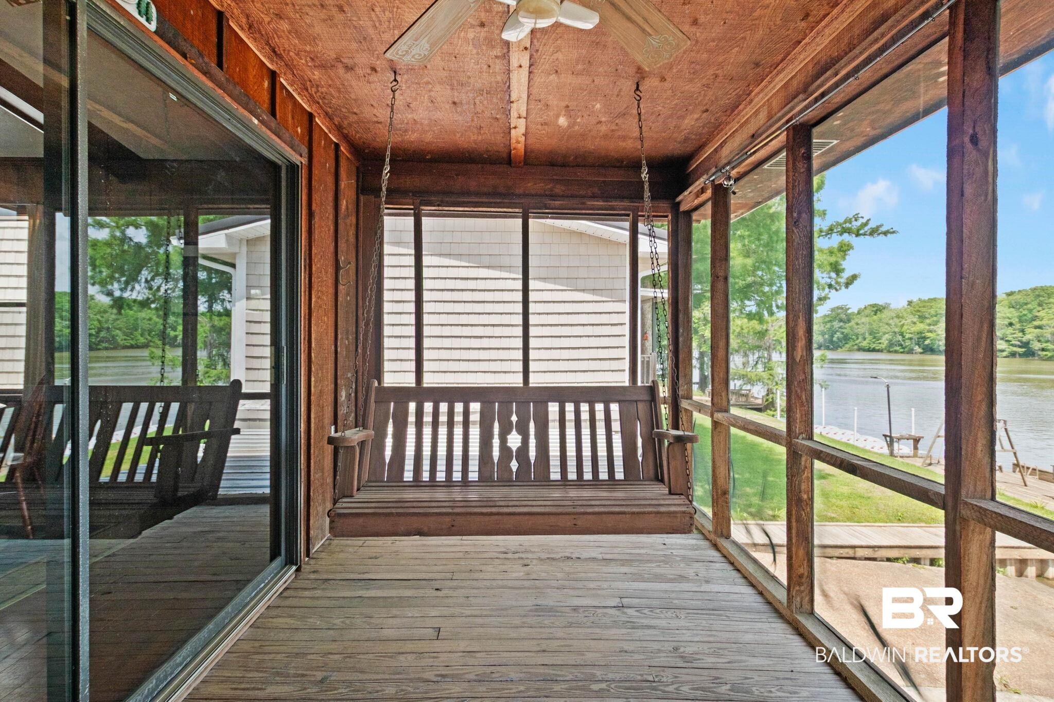 8153 Bryant's Lndg Road Stockton, AL 36579 - Photo 60 of 87 Screened porch featuring wood-finish flooring and ceiling, a built-in porch swing, and waterfront access