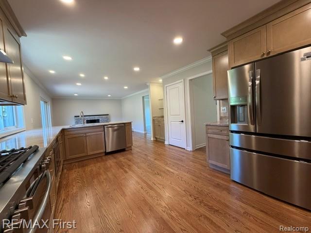 971 Canterbury Road Grosse Pointe, MI 48236 - Photo 12 of 30 Hardwood flooring, recessed lighting, stainless steel appliances, kitchen island with sink, and sliding glass door