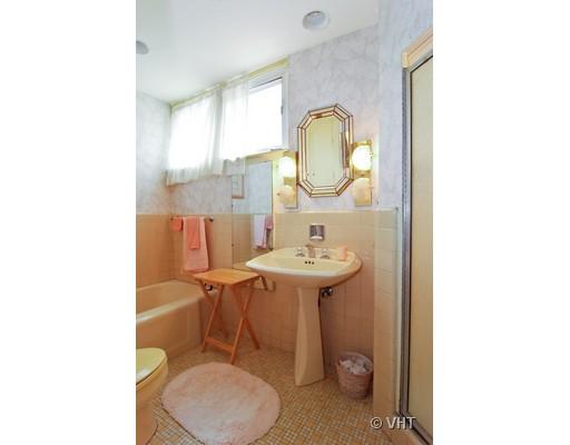 562 West Stratford Place Chicago, IL 60657 - Photo 7 of 10 a bathroom with a sink toilet and mirror