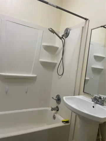 a bathroom with a sink a mirror and a shower