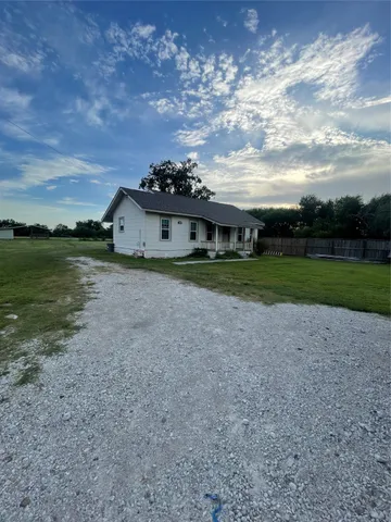 a view of a town with barn in the background