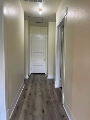 a view of hallway with wooden floor