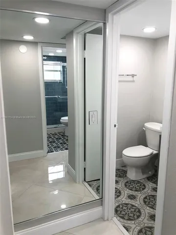 a view of a livingroom with a ceiling fan and wooden floor