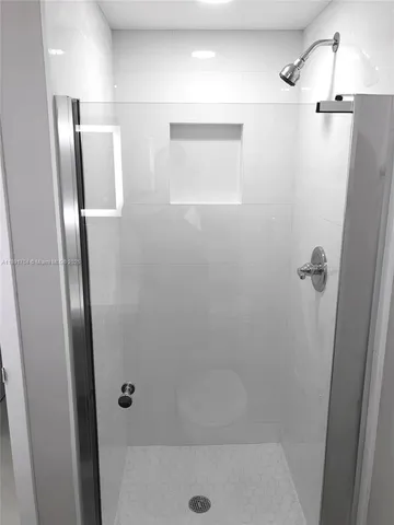 a view of a bathroom with a shower and a sink
