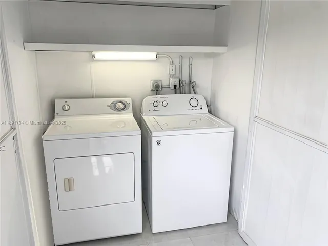 a view of a bench in the garden near a lake