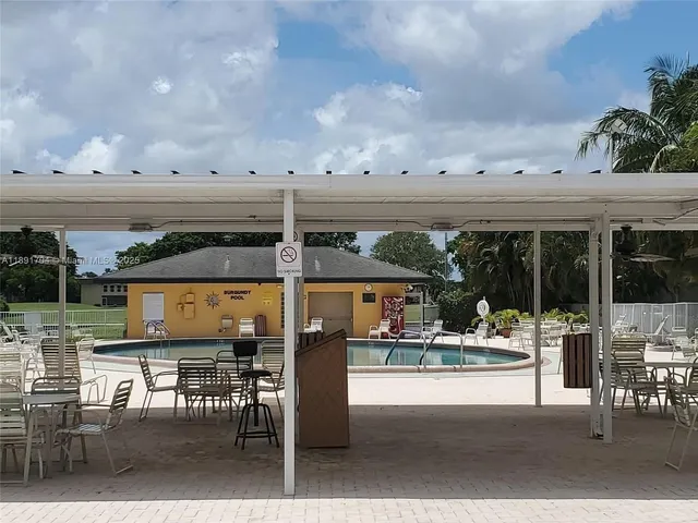 a backyard of a house with table and chairs