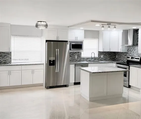 a kitchen with refrigerator and cabinets