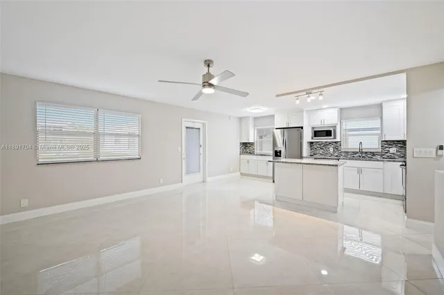 a kitchen with stainless steel appliances granite countertop a refrigerator a stove a sink and a refrigerator