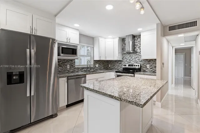 a kitchen with granite countertop a stove and a sink